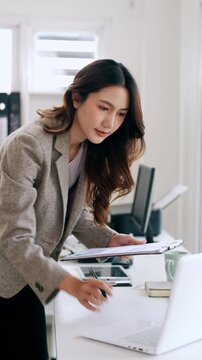 Business woman working on laptop at desk in modern office. reviewing document. Entrepreneur career concept.