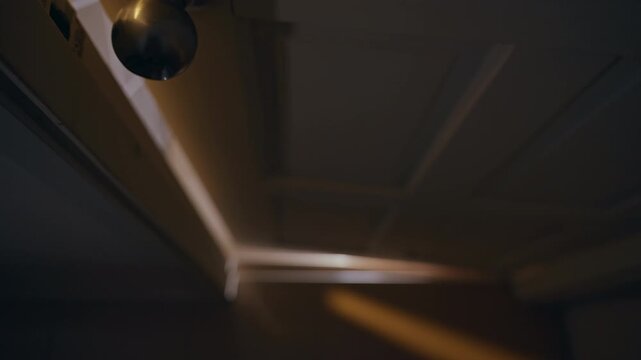 Low Angle View of Interior Door Closing Into Darkness After Brief Opening, Suspense, Mystery, Fear, Horror Atmosphere, Cinematic Thriller