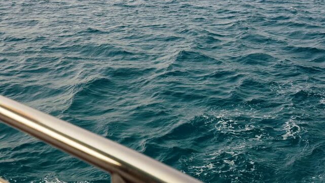 Egypt Red Sea aerial cruise view from sailing boat yacht deck steel railing on marine waves.

