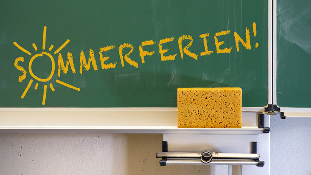 School classroom background - Empty green school blackboard with sponge, close-up detail
