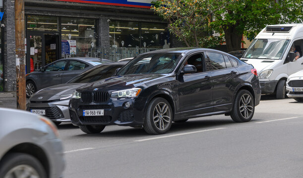 July 8, 2026, Tbilisi, Georgia Black BMW X4 SUV Driving on City Street