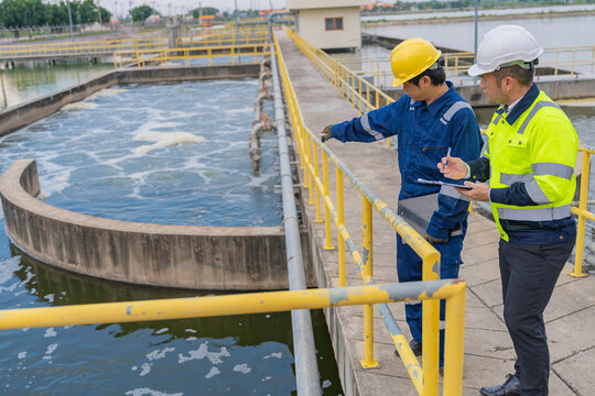 Environmental engineers work at wastewater treatment plants,Water supply engineering working at Water recycling plant for reuse,Technicians and engineers discuss work together.
