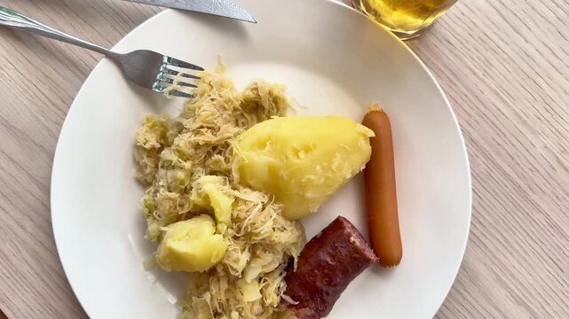  Traditional Choucroute Alsatiane with Sauerkraut Sausages and Potato Served with Beer