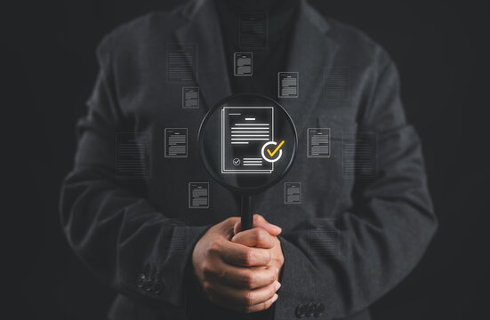 Businesswoman holding a magnifying glass, showing Audit Document ,quality assessment management With a checklist, business document evaluation process, market data report analysis and consulting.