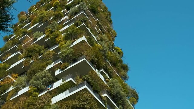 Vertical garden building with lush greenery and trees integrated into modern architecture, Milan, Italy. Vertical forest and landscaping, innovative architecture, urban sustainability