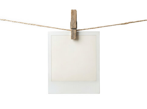 Blank paper card hanging on a wooden clothespin with rope