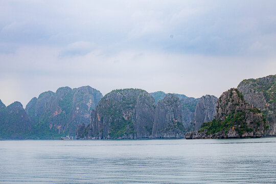 Beautiful Halong bay with layer of limestone mountians and boats in Vietnam.