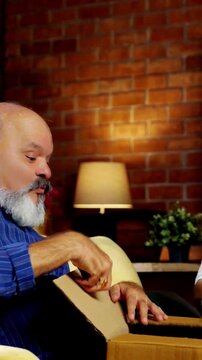 Charming retired Indian couple shares a heartwarming moment by exchanging surprise gifts expressing  joy, excitement and togetherness as they celebrate their bond.