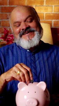 Playful retired Indian couple shares a joyful moment in their modern home, as they happily put coins into a piggy bank, celebrating  simple pleasures of life together