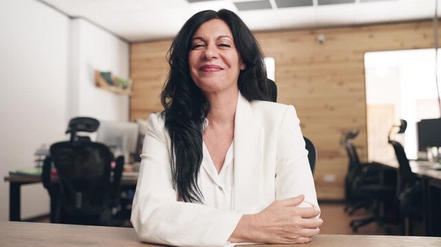 Confident senior female manager listening and smiling during an online conference. Webcam point of view of a woman having a job interview