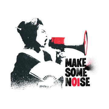 Woman uses a megaphone to speak at an event in a city setting during daylight hours