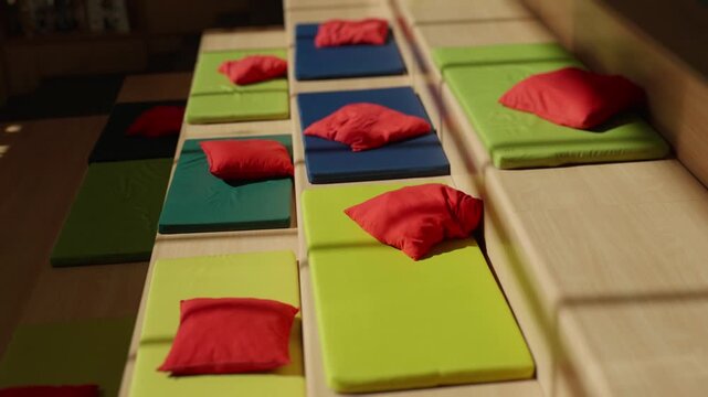 Colorful cushions on tiered seating in modern school auditorium