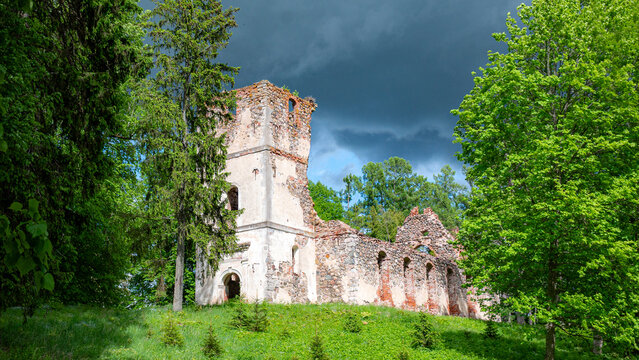Sunny landscape with old stone church ruins, The church was a brick building with a rectangular chancel and a protruding tower with a baroque spire.