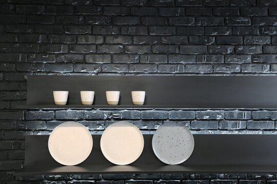 Plates on a black shelf in the kitchen