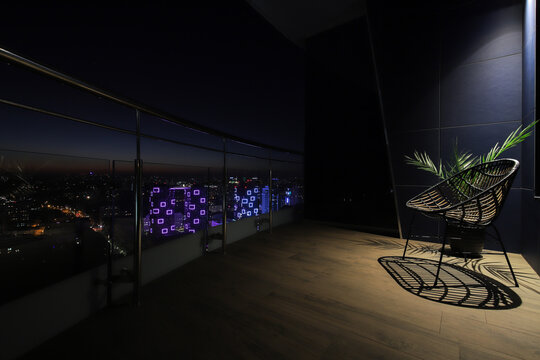 Chair on the open terrace of the apartment at night