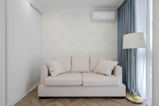 Beige sofa in the room interior