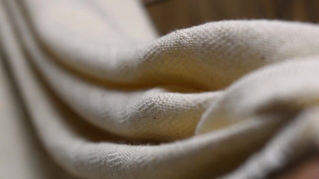 White Jacquard Fabric Texture Close Up with Elegant Woven Pattern shown in cinematic focus shift 