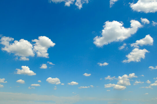 Beautiful bright blue sky with a mixture of soft altocumulus and light cirrus white clouds, serene natural background template