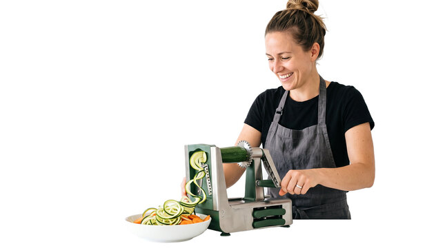 Spiralizing Vegetables with a Smile: A smiling woman in an apron joyfully uses a spiralizer to create vegetable noodles, preparing a healthy and colorful meal.