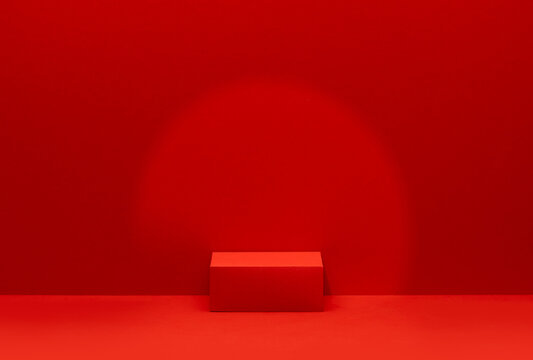 Clean bright red studio scene with a single rectangular product pedestal positioned right of center on a plain red background, designed for product placement, commercial mockups and advertising .