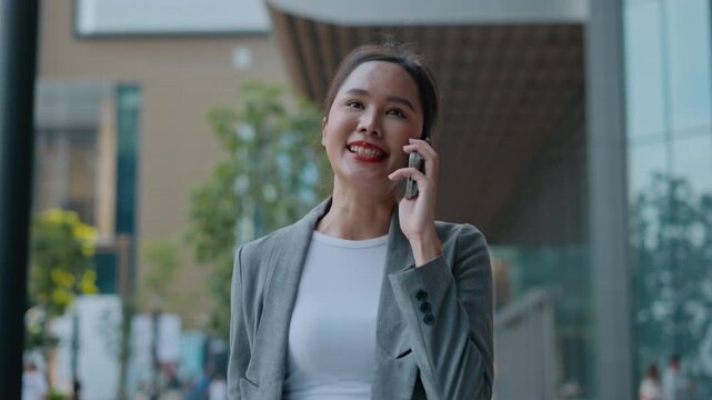 Portrait of young woman standing outdoor happy smiling use mobilephone.Handsome young asian woman dressed casually walking spending time outdoors at city urban,carrying backpack,using mobile phone