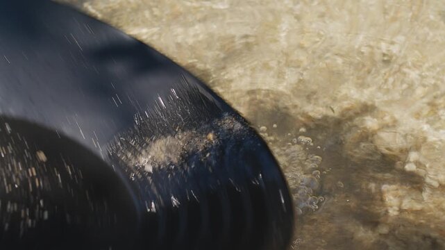 Close-up of a gold digger's plate to wash river sand and search for gold grains on a sunny day.