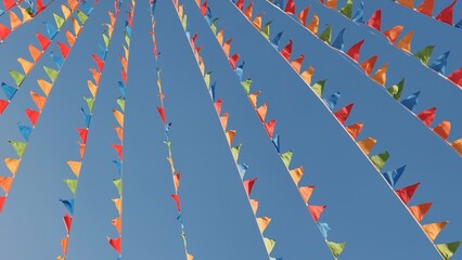 Fototapeta premium Colorful triangular flags waving in the wind in Moscow
