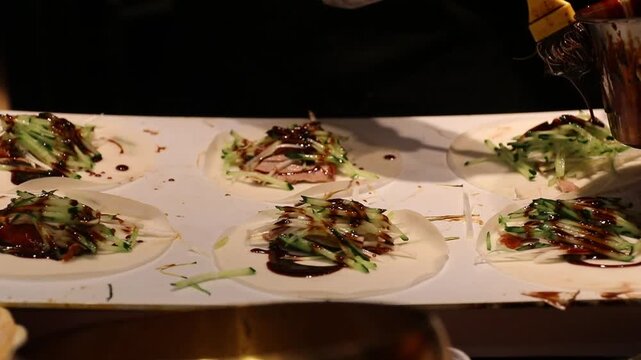 Pancake wrapper duck  with shredded cucumber and savory sauce rolled warm street food scene, pancake wrapper topped with sliced cucumber and savory sauce