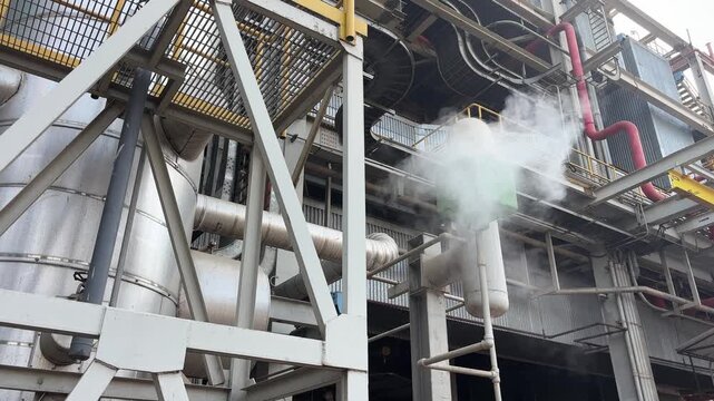 Industrial plant emits steam from boiler venting