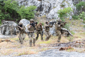 Fototapeta premium Military participate in a patrol in forest terrain