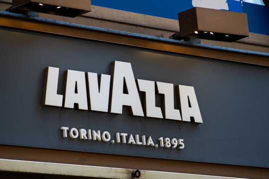 Lavazza Coffee Sign on the Wall with Torino Italia 1895 Inscription at a Cafe Restaurant Store. Milan, Italy - June 24, 2026