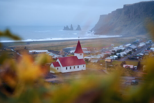 Red church above black sand beach, V&iacute;k, Iceland