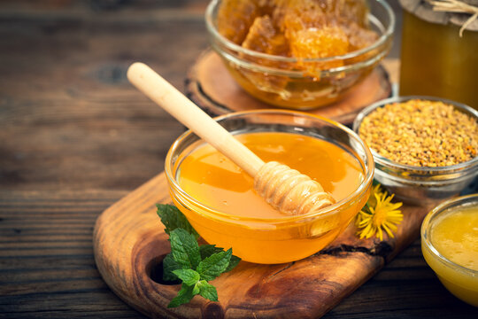 Fresh honey in the jars, with honeycomb and bee pollen