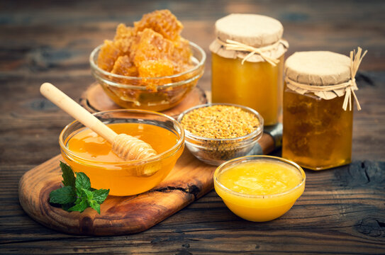 Fresh honey in the jars, with honeycomb and bee pollen