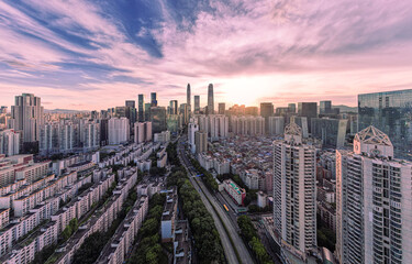 Shenzhen Futian skyline at sunset with dramatic clouds over urban cityscape © DinhThi