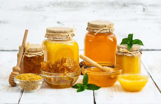 Fresh honey in the jars, with honeycomb and bee pollen