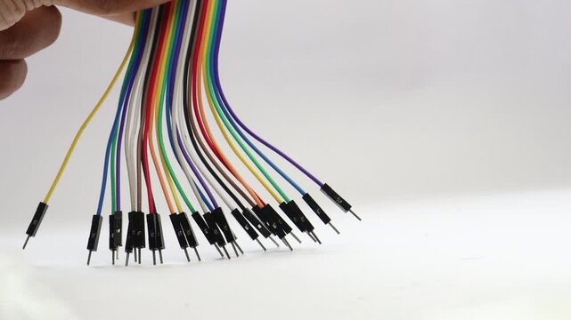 Jumper cables with a view of its connecting pins on a white background. Jumper wires are electronic component used in breadboard electronics
