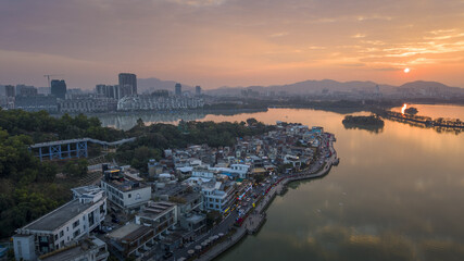 Fototapeta premium Sunset over Riverside Village and City Skyline in Zhaoqing, Guangdong