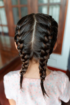 Girl With Braids in Hair at Home