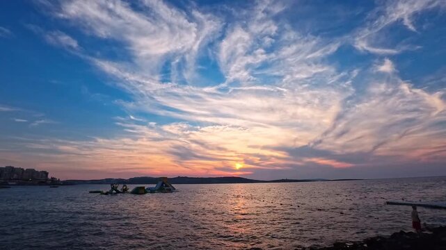 Colorful Sunset Sky Above Mediterranean Coast,  Bugibba Beach, Malta - TILT UP VIDEO - NO AUDIO