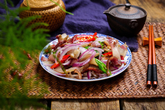 Spicy octopus salad with red onion and chili on rustic table