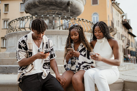 Friends using mobile phones in the city