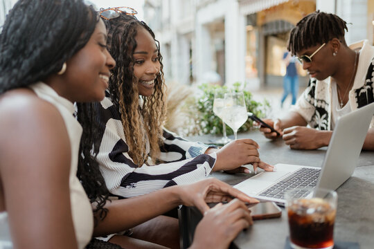Friends using technology in the city