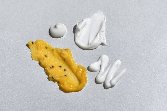 Different Shapes and Textures of Skincare Products on Gray Background