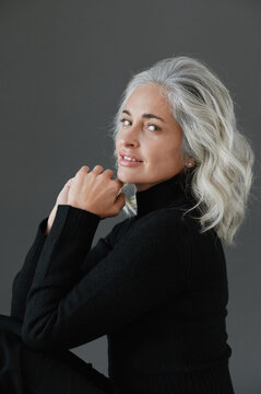 Portrait of woman against dark background