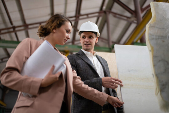 Employer exploring stone samples with architect