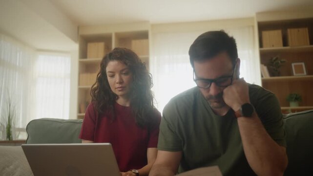 Couple, stress and laptop in financial crisis, mortgage bills or working on expenses together at home. Stressed man and woman in budget, invest or insurance loan debt for finance planning on computer