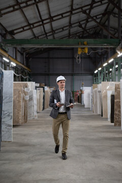 Businessman walking in marble warehouse