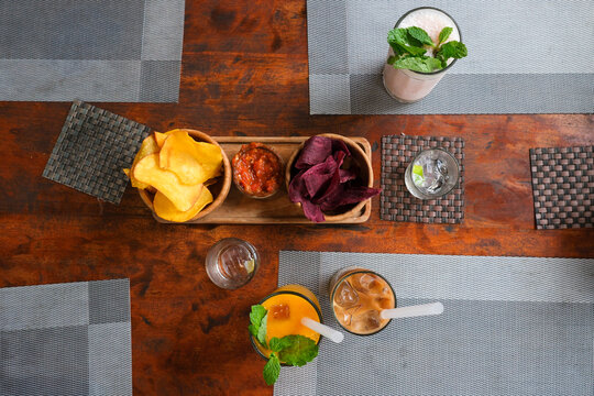 Colorful Tropical Drinks and Snacks on Wooden Table