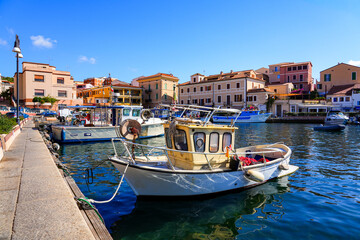 Obraz premium Fishing boat moored in Cala Gavetta in La Maddalena, capital city of the eponym archipelago located in the Mediterranean Sea in north-east of Sardinia, Italy